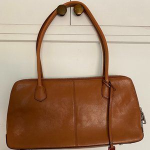 Hobo tan leather purse with red fabric inside.